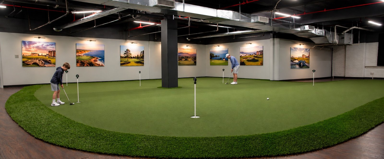 Adult and junior practicing putting on the large indoor green at APEX Golf Lab