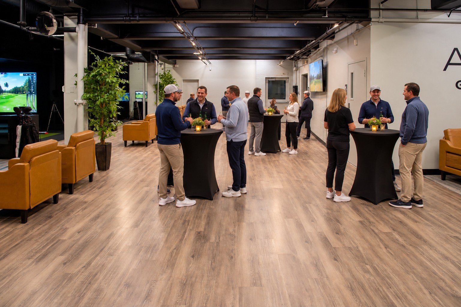Small group social and corporate gathering at APEX Golf Lab with high-top tables
